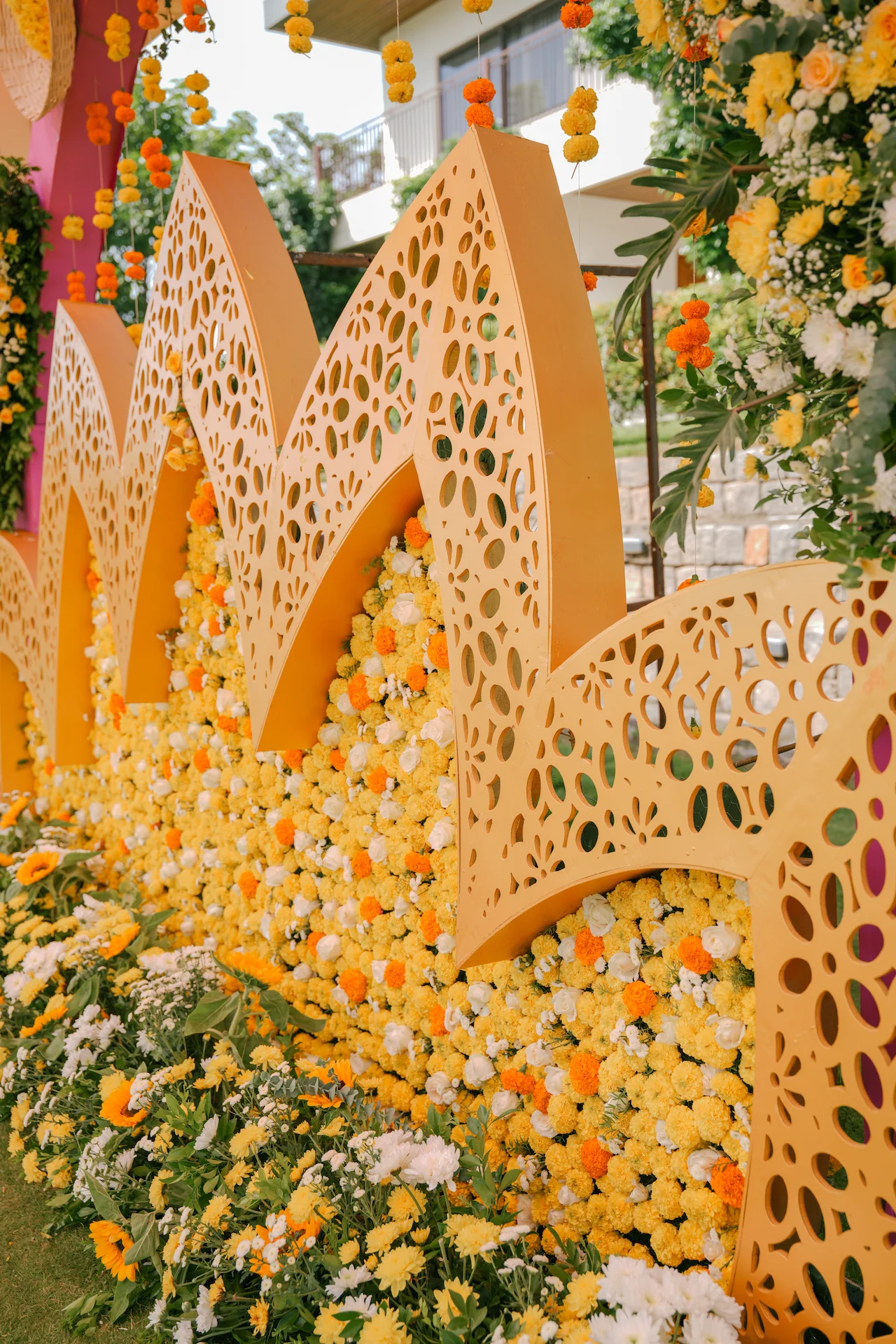Detailed view of lotus-shaped Haldi backdrop with floral wall and layered decorative cutwork panels